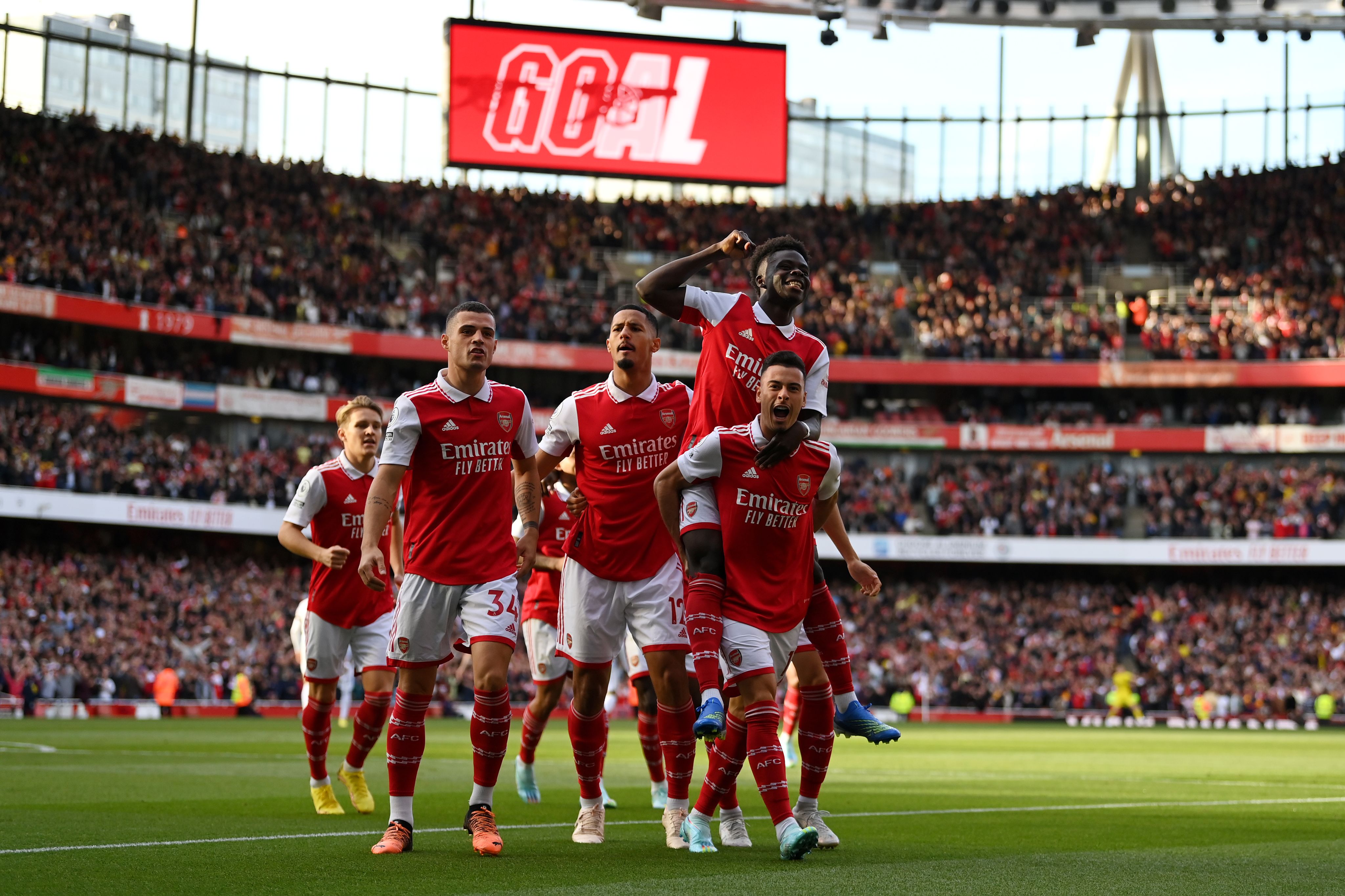 Bukayo Saka celebrates with teammates after Arsenal's first goal against Liverpool at Emirates Stadium in October 2022