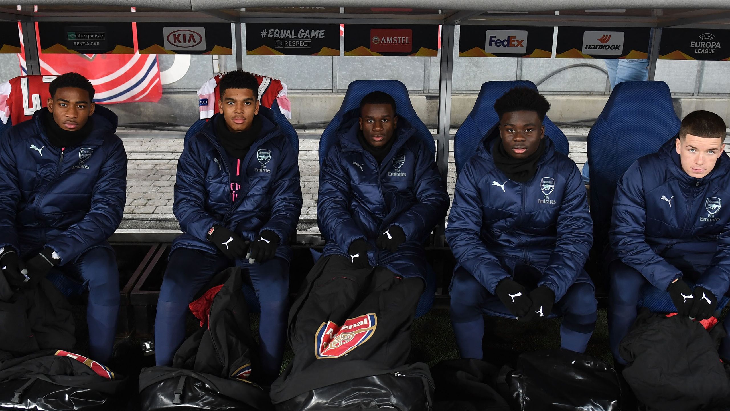 Bukayo Saka on the bench with his fellow academy team-mates