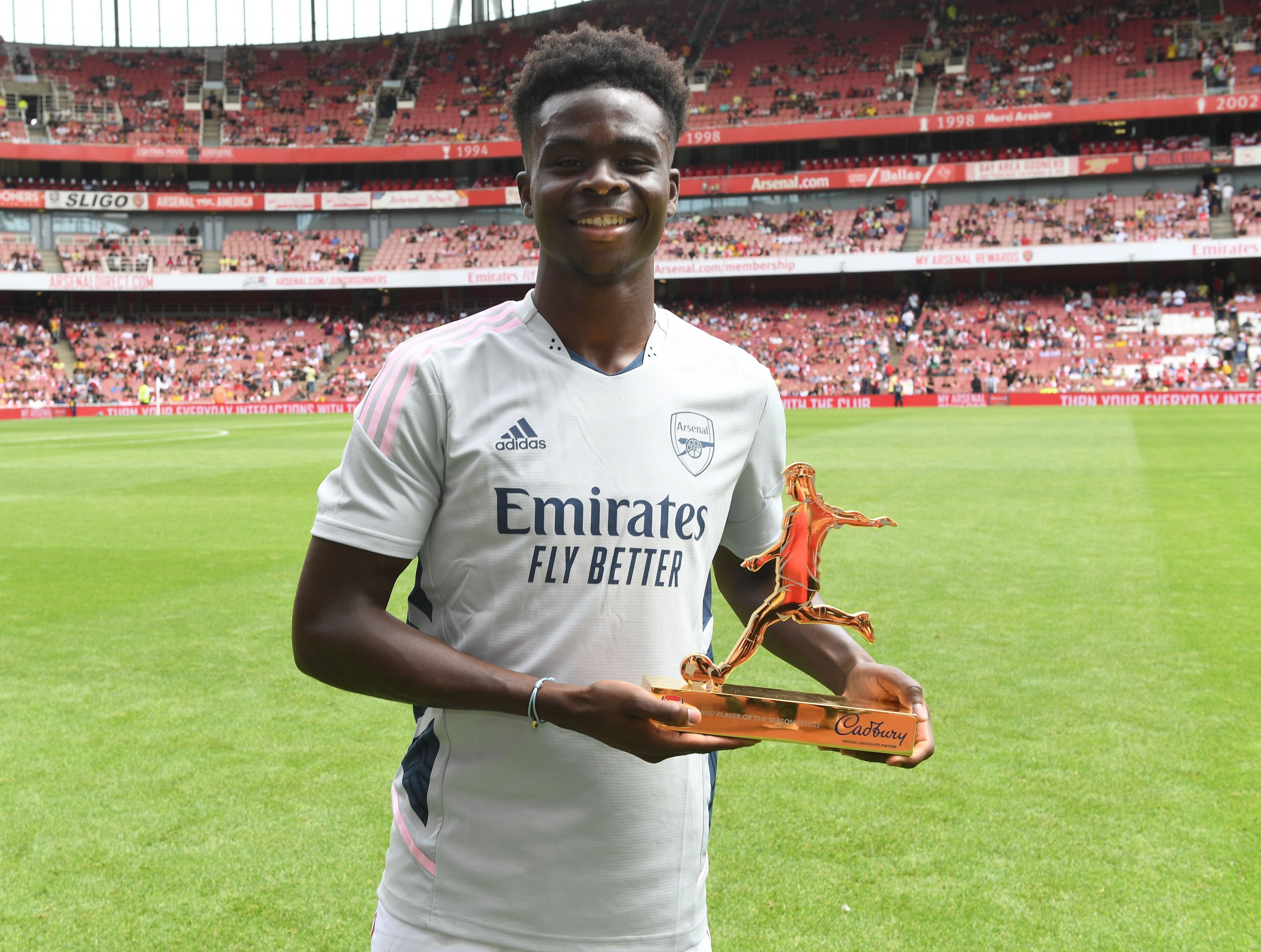 Bukayo Saka poses with the Arsenal Player of the Season award at Emirates Stadium