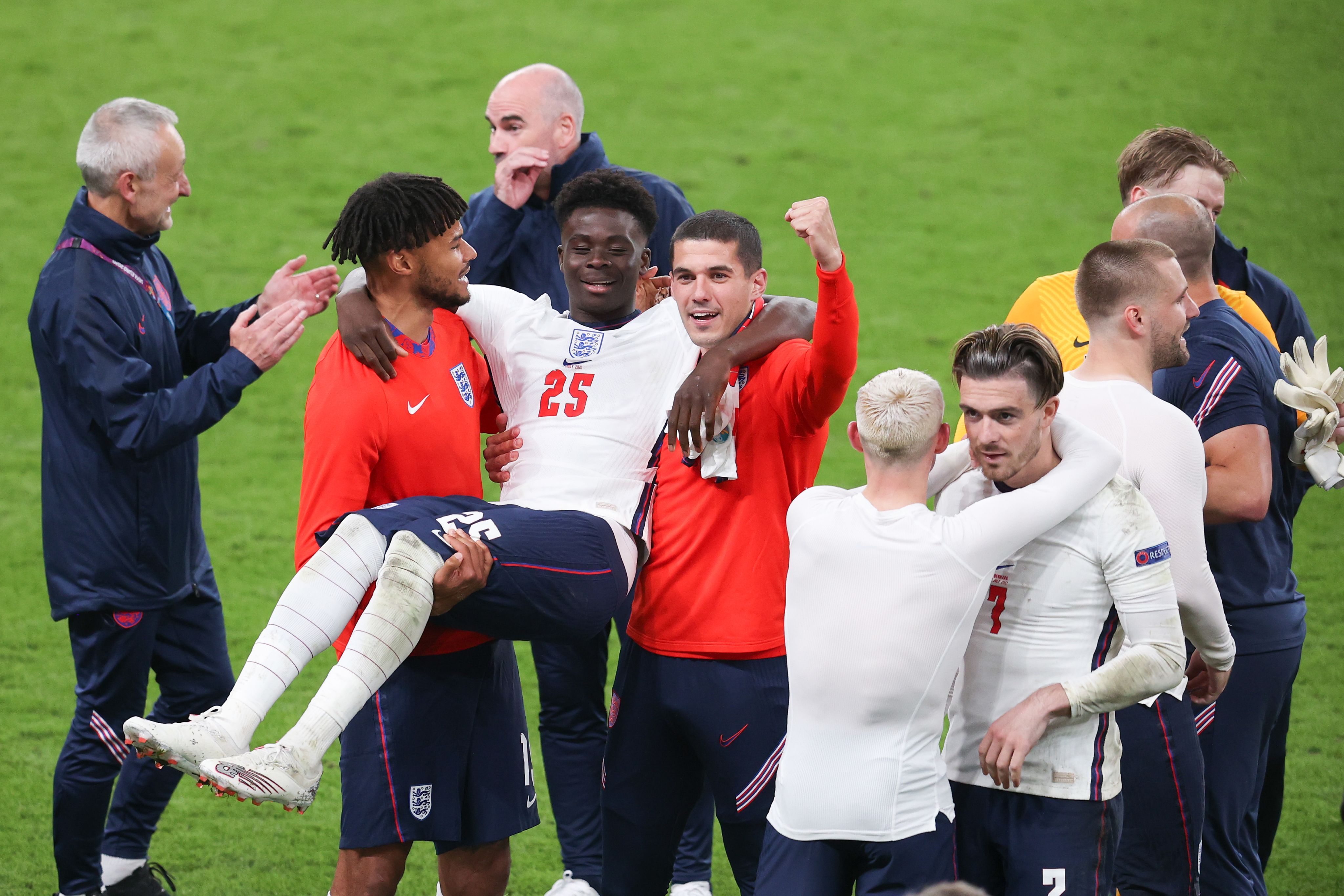 Tyrone Mings and Conor Coady chair Bukayo Saka off the pitch following England's victory in the Euro 2020 semi-final against Denmark at Wembley Stadium in July 2021
