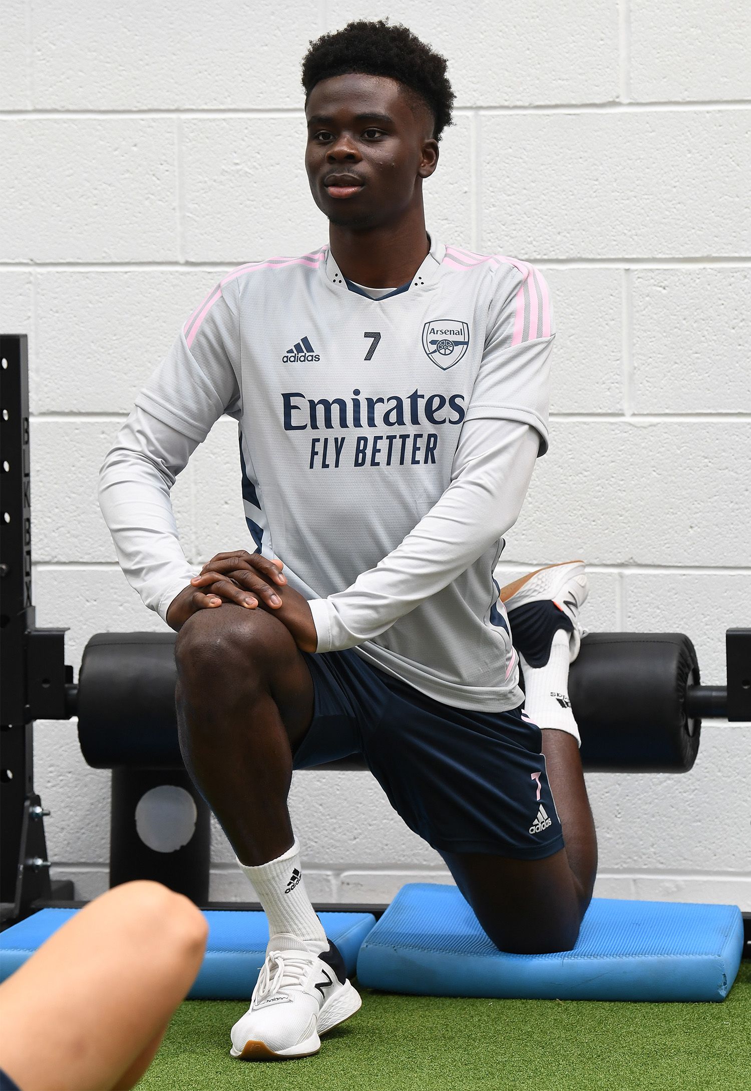 Bukayo Saka stretching in the gym