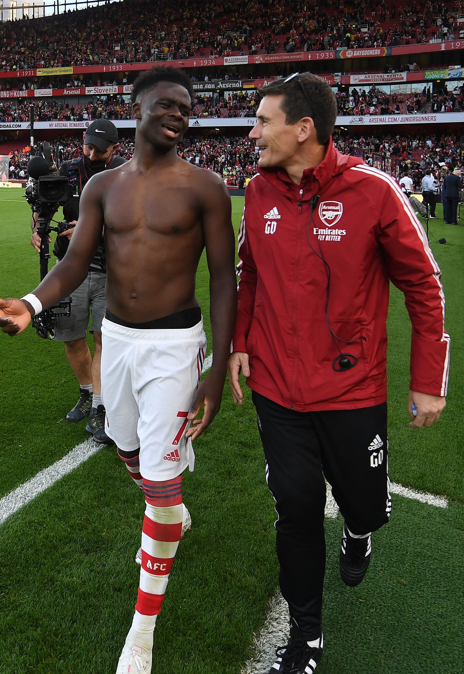 Bukayo Saka walking with Dr Gary O'Driscoll on the pitch at the end of the game