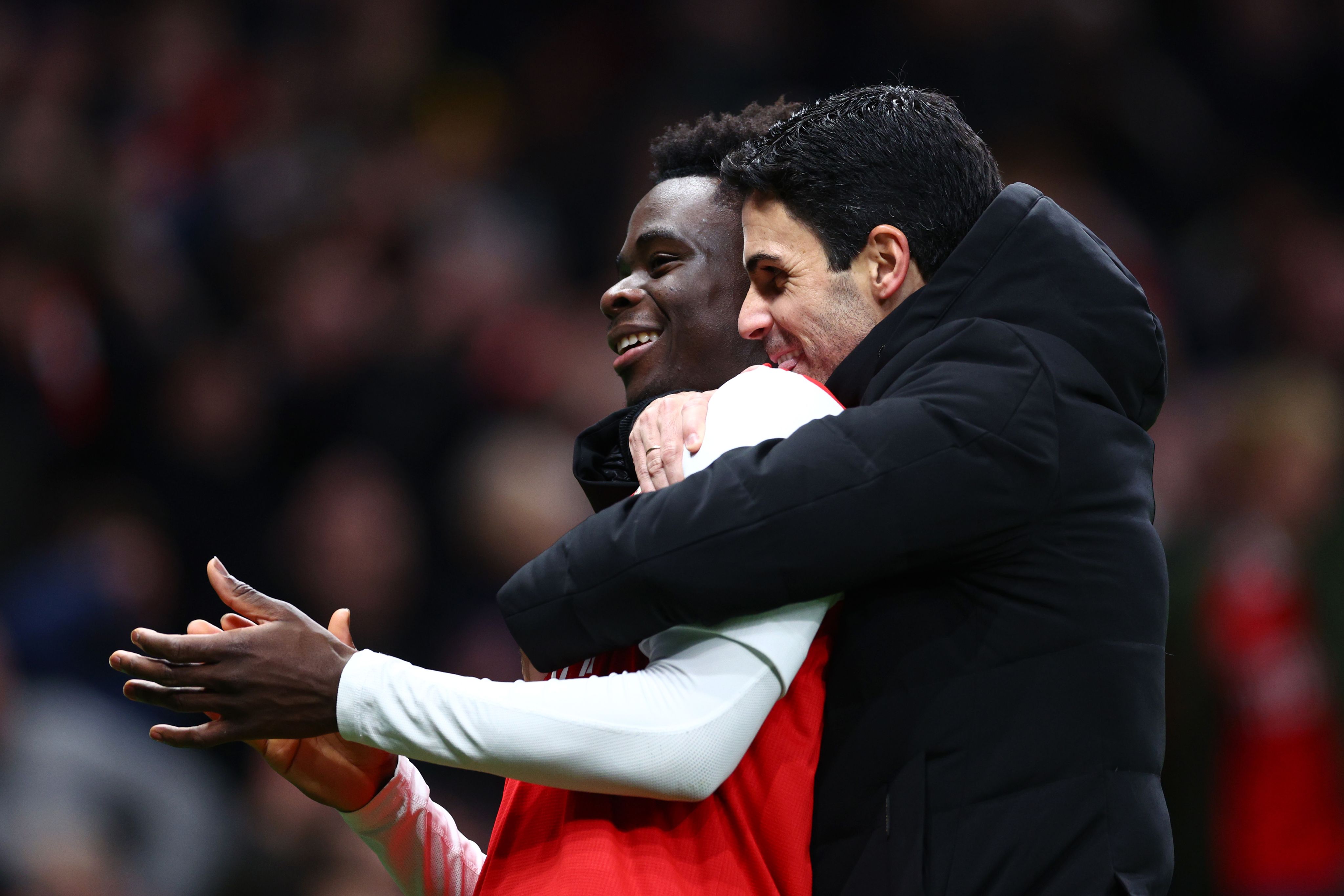 Mikel Arteta hugs Bukayo Saka after Arsenal's victory over Tottenham Hotspur in January 2023
