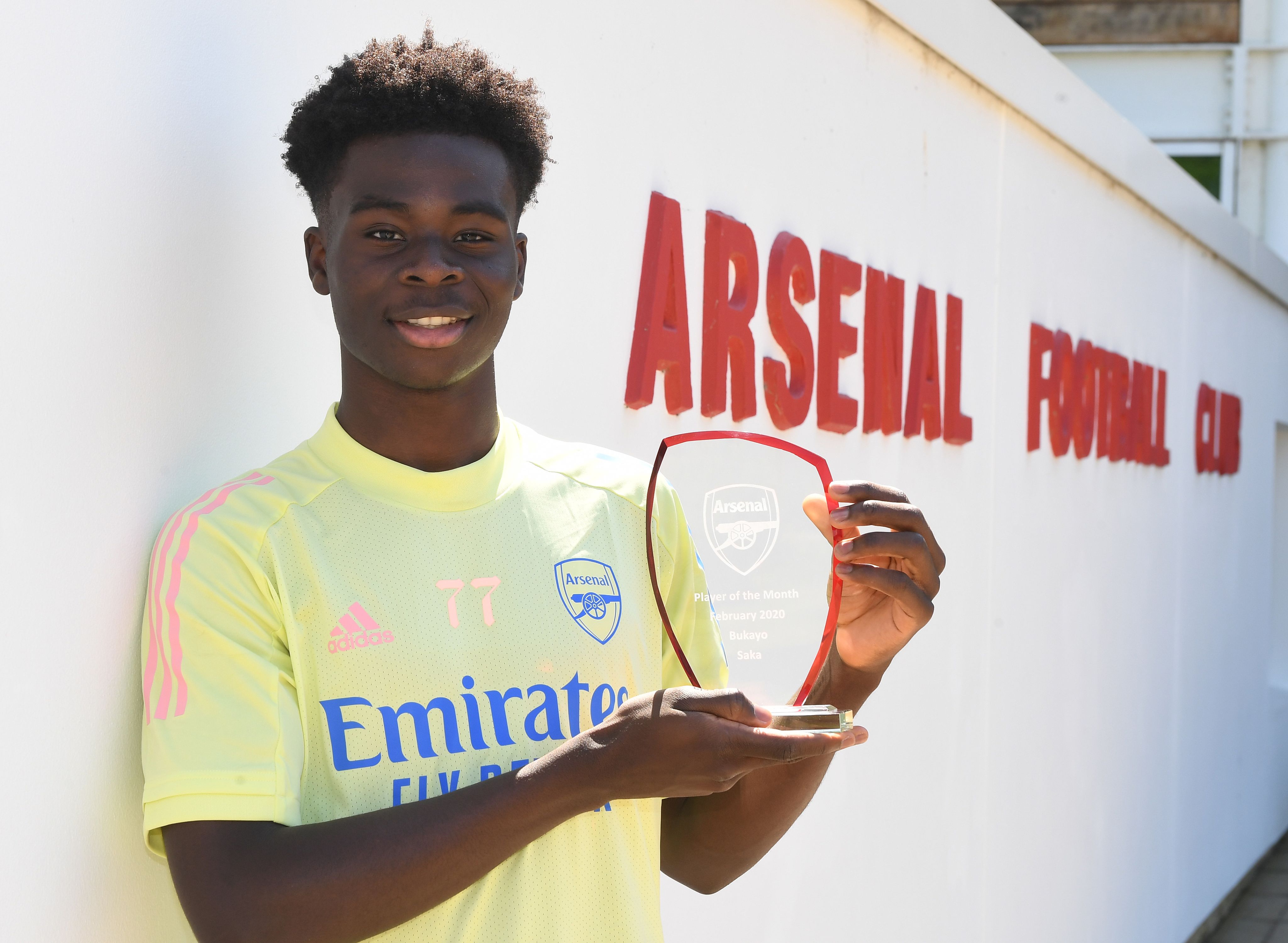 Bukayo Saka poses with his first Arsenal Player of the Month award